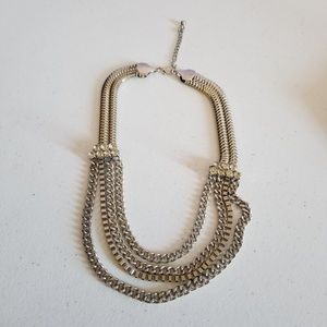 Silver multi-strand necklace with clear stones.